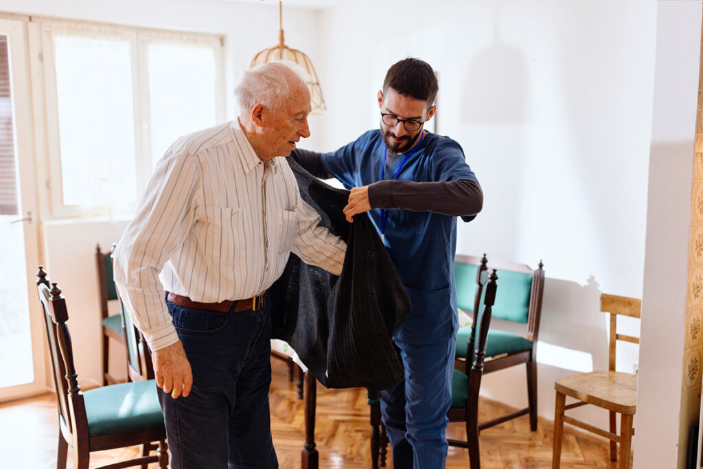 Older Adults Male Nurse Taking Care Of A Senior Man At Home