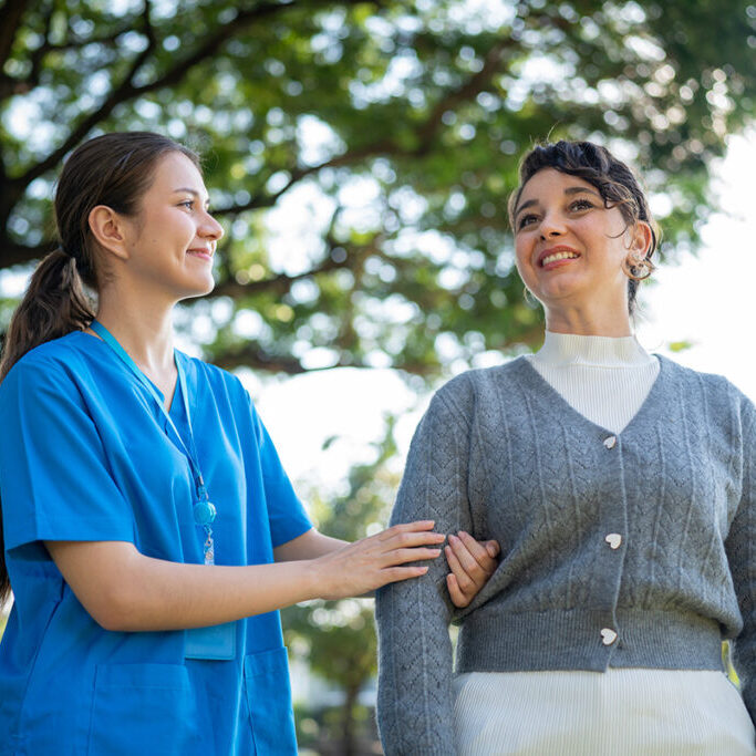 Home Care Nurse Supporting Elderly Woman