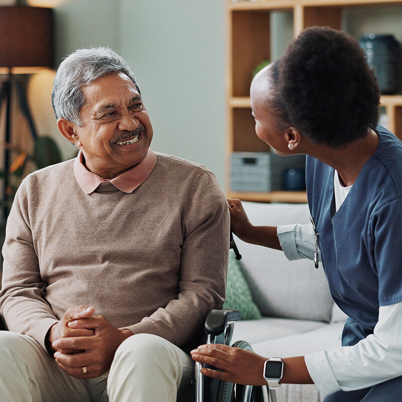 Nurse Old Man And Wheelchair For Medical Support Wellness And Person With Disability People Healthcare Worker And Patient With Service Or Help With Happiness Talking Or Discussion For Advice